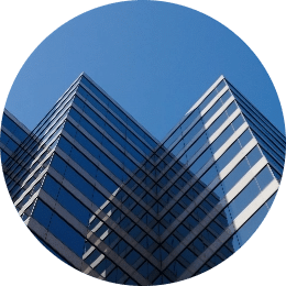Dream Office REIT, a tall glass building reflects the bright blue clear sky