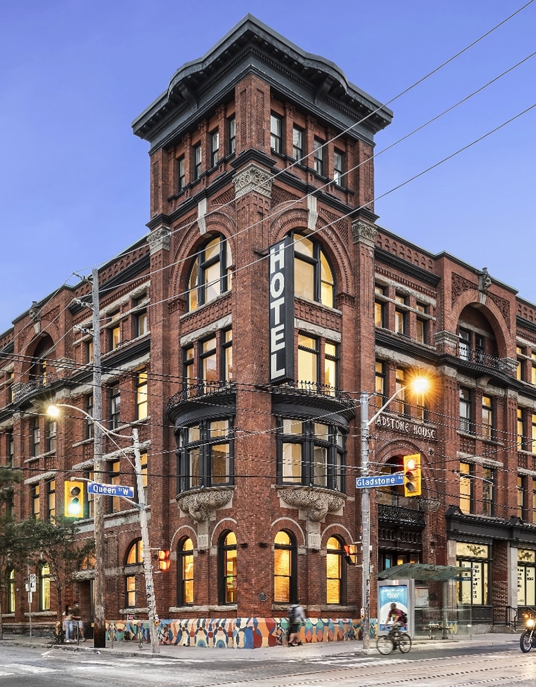 Gladstone Hotel, a red‑brick Romanesque building in Toronto with stone accents, arched windows, terracotta detailing, and a corner tower