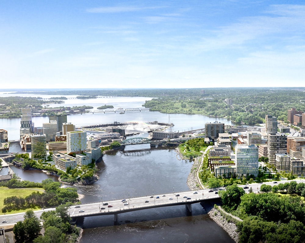 Aerial view of Zibi cityscape featuring modern buildings, green spaces, bridges, and a central river under a clear sky with light clouds