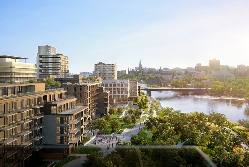 Scenic urban landscape featuring modern residential and commercial buildings, a river with a bridge, and a park with walking paths and trees under a clear sunny sky