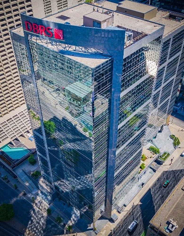 Adelaide Place: A bird's-eye view of a large all window building in Downtown Toronto, featuring a striking red sign that reads DBRS