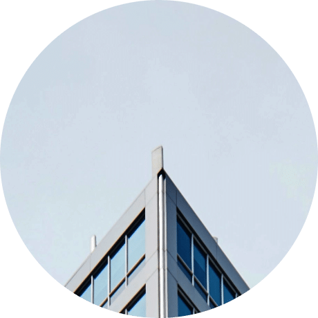 a corner image of a office building with floor to ceiling windows